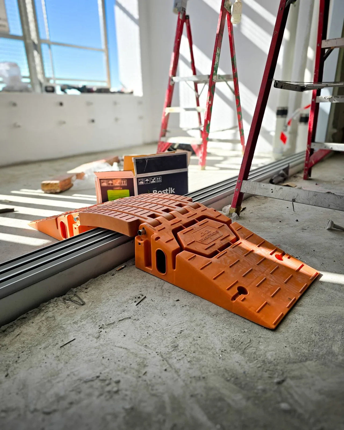 Orange ToughTracks ramps protecting a sliding door opening on site